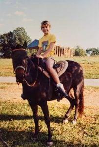 Young Stephanie on her pony, learning animal care and responsibility on the family farm
